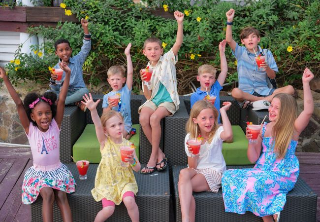 A Group Of Children Holding Cups