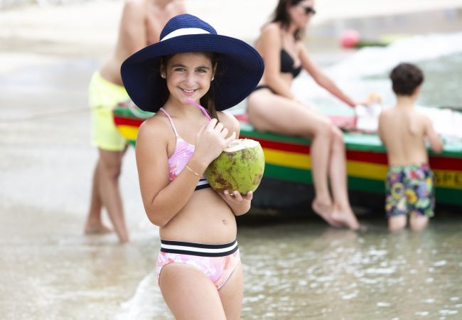 A Girl In A Swimsuit Holding A Watermelon